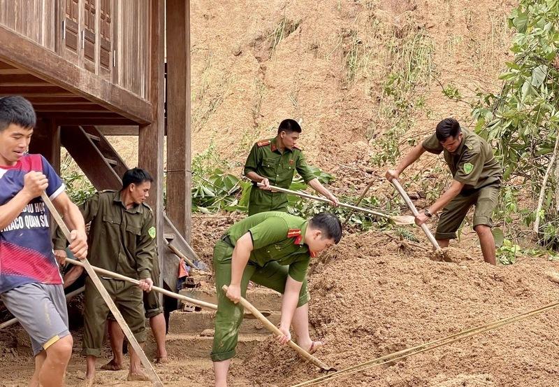 Sau khi tiếp cận được điểm bị cô lập, lực lượng công an đã hỗ trợ người dân dọn dẹp bùn đất, ổn định cuộc sống. Ảnh: Minh Phương